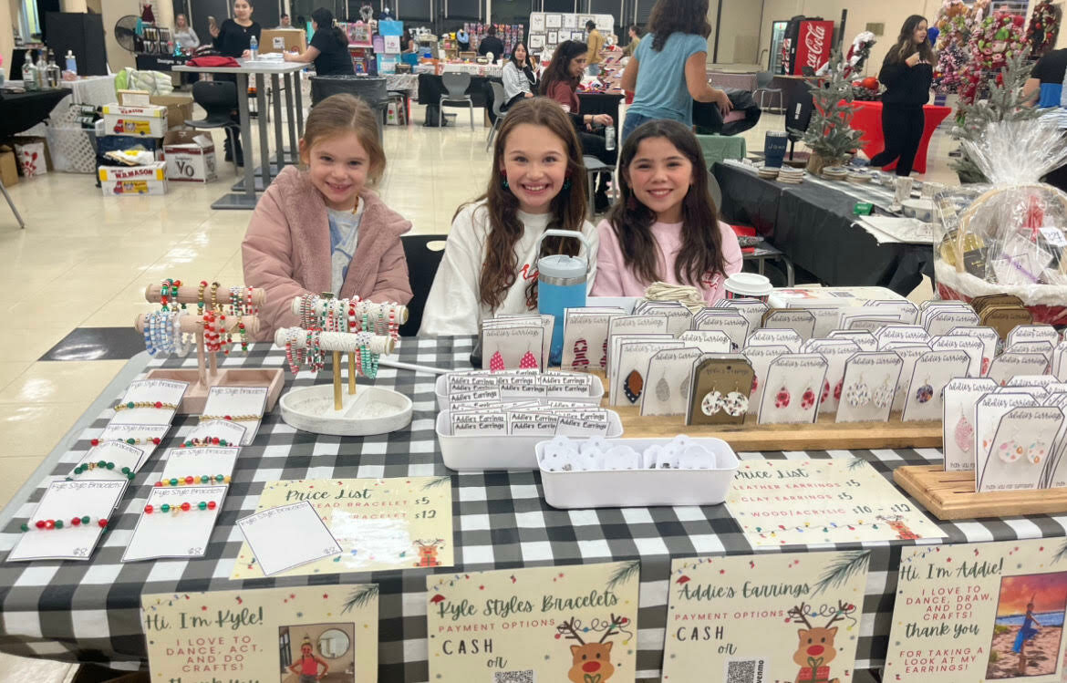 Three young ladies sell handmade earrings and bracelets. The bracelet designer, Kyle, enjoys dancing, acting, and doing crafts. Addie, the earring designer, loves dancing, drawing, and doing crafts.